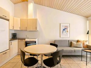 a living room with a table and a couch at Holiday Close To Beach Golf And Café in Pandrup