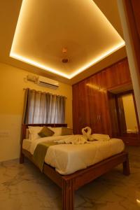 a bedroom with a large bed in a room at Gayathri Nest in Udupi