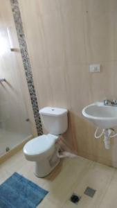 a bathroom with a toilet and a sink at Terramia Suite in Cabudare +1 photo