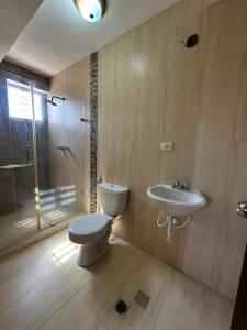 a bathroom with a toilet and a sink at Terramia Suite in Cabudare