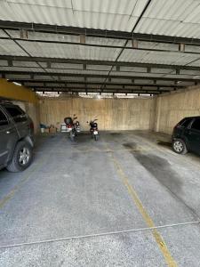 a parking garage with two motorcycles parked in it at Terramia Suite in Cabudare