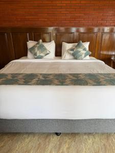 a large bed with white sheets and pillows at The Mungseng Villa Bali in Singaraja +47 photos