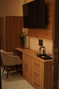 a room with a desk with a television and a chair at Kaya Nature Resort in Ajabgarh