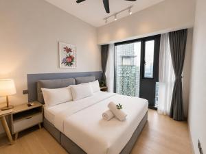 a bedroom with a white bed and a large window at STAR Residence KLCC - Dreamland Holiday Home in Kuala Lumpur +135 photos