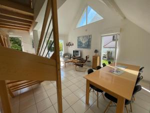 a living room with a wooden table and chairs at Maisons avec terrasse et parking in Colmar