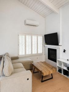 a living room with a couch and a fireplace at Two Bedroom Beach Apartment in Sunset Beach