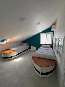 a bedroom with two beds and a window at Two Bedroom Beach Apartment in Sunset Beach
