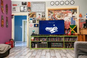 a living room with a flat screen tv on a entertainment center at Habitat Hostel in Belgrade