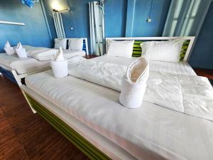 two beds with white shoes sitting on top of them at Longbeach Kohphayam in Ko Phayam +26 photos