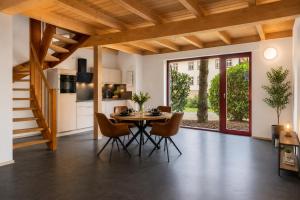 a kitchen and dining room with a table and chairs at Elementa City Lodge Quedlinburg 2 in Quedlinburg