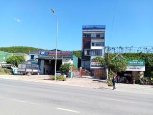 a person walking down a street next to a building at G7 Hotel in Quyền Hoành