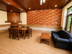 a living room with a table and a couch at Royal Kalinga Cottage near volvo bus stand, Manali - Best Property of Manali 2025-26 in Manāli