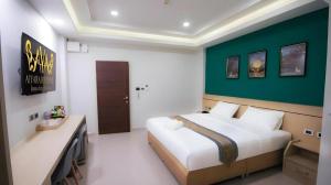 a bedroom with a large bed and a green wall at Aiyara Riverine Hotel, Nakhon Phanom in Ban Nong Puk +38 photos