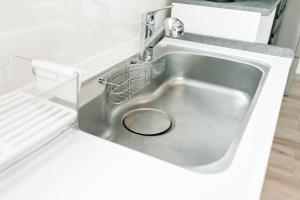 a sink in a refrigerator with a strainer in it at AOI Villa Biei in Biei +47 photos