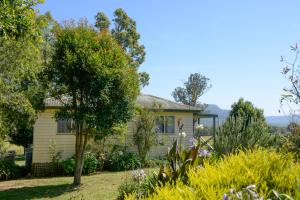 a house with a garden in front of it at The Big Bell Farm in Kangaroo Valley