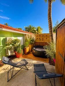 a patio with two chairs and a large tire at Cocon Romantique in La Saline les Bains