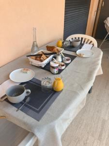 a table with a tray of food and drinks on it at Chambre chez l habitant terrasse vue mer in Sainte-Maxime