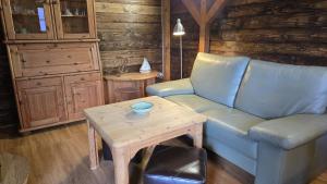 a living room with a blue couch and a table at Strandbude in Heringsdorf