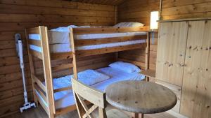 a room with two bunk beds and a table at Strandbude in Heringsdorf