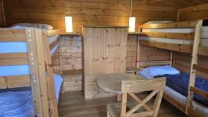 a log cabin with two bunk beds and a table at Strandbude in Heringsdorf +14 photos