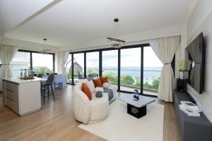a living room with a couch and a table and a kitchen at Diane Homes Evoque nyali in Mombasa