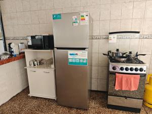 a kitchen with two refrigerators and a stove at Magisterio in Arica
