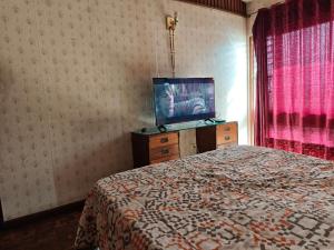 a bedroom with a bed and a flat screen tv at Magisterio in Arica