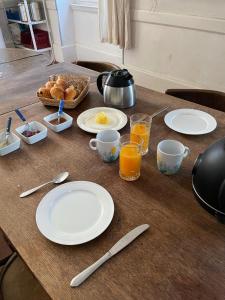 a table with plates of food and drinks on it at Chateau de Bouquetraud in Franchesse