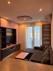 a living room with a couch and a television at Katarina in Kaštela