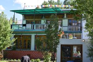 a man standing in front of a house at Larikha stay chumpa in Leh