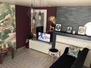 a living room with a couch and a fireplace at Un petit truc en plus in Brienne-le-Château