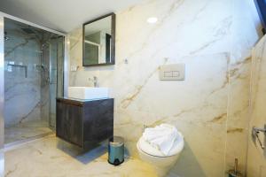a bathroom with a toilet and a sink and a shower at Dolunay Villas - 2 in Dalyan +16 photos