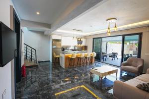 a living room and kitchen with a couch and a table at Dolunay Villas - 2 in Dalyan