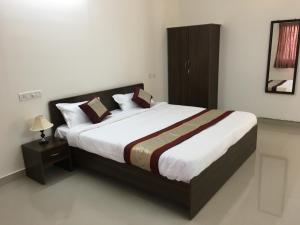 a bedroom with a large bed in a room at Sun Shine in Chennai