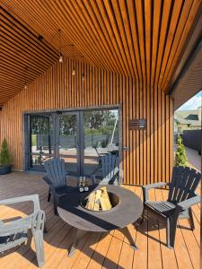 a patio with a table and chairs and a fire pit at СвояХата in Svityazʼ