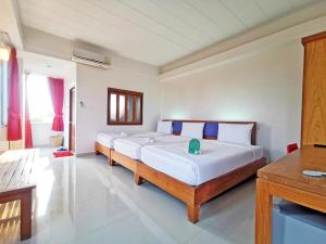 a bedroom with two beds in a room at J2 Hotel in Mae Sot