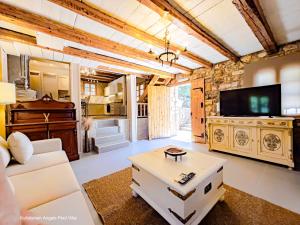 a living room with a couch and a tv at Kefalonian Luxury Villas in Kástron