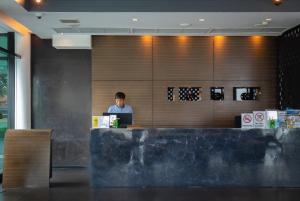 a man sitting at a desk with a laptop at Z Through By The Zign in North Pattaya +121 photos