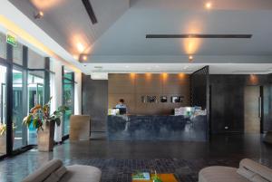 a lobby with a reception desk in a building at Z Through By The Zign in North Pattaya