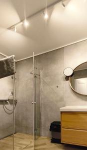 a bathroom with a shower and a sink and a mirror at Pensjonat Kotwica in Kuźnica +50 photos