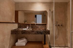 a bathroom with a sink and a shower at The ABY in Tel Aviv +47 photos