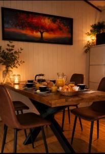 a dining room table with food on top of it at Chalet Bosrust met serre & privéparking Natuur nabij Maastricht in Lanaken