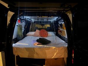 a small bed in the back of a van at Caddy Car in Brisbane