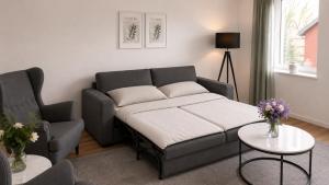 a living room with a couch and a chair at Apartment -Wohnung Herford in Herford