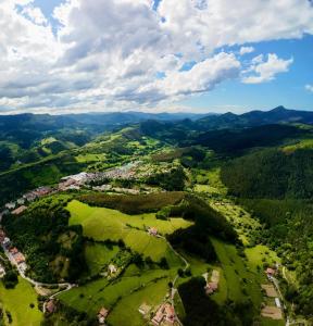 an aerial view of a village in the hills at Lutzin Etxea, Caserío Vasco con piscina, jardín y parking, a 15 min de Bilbao in Llodio