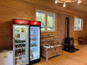 a room with a refrigerator and a stove at Glamping Brodej in Vitanje