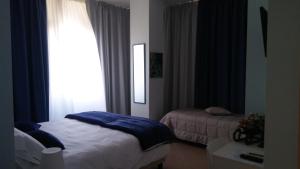 Posteľ alebo postele v izbe v ubytovaní B&b Bagheria
