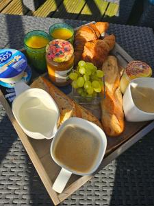 a tray of bread and pastries on a table at appartement Plume de repos in Marboué