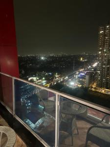 a balcony with a view of a city at night at THE MOONLIGHT STUDIo in Ghaziabad