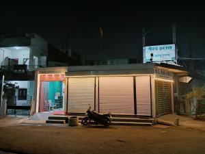 a motorcycle parked in front of a building at night at Shree DashbhujaNath Stays in Ujjain